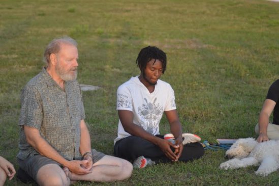 Stephen Gillum (on the left) leading meditation at the Bayfront on Apr. 12th after the one day fast some students participated in for the Boycott Wendy's campaign. Photo by Kelly Wilson